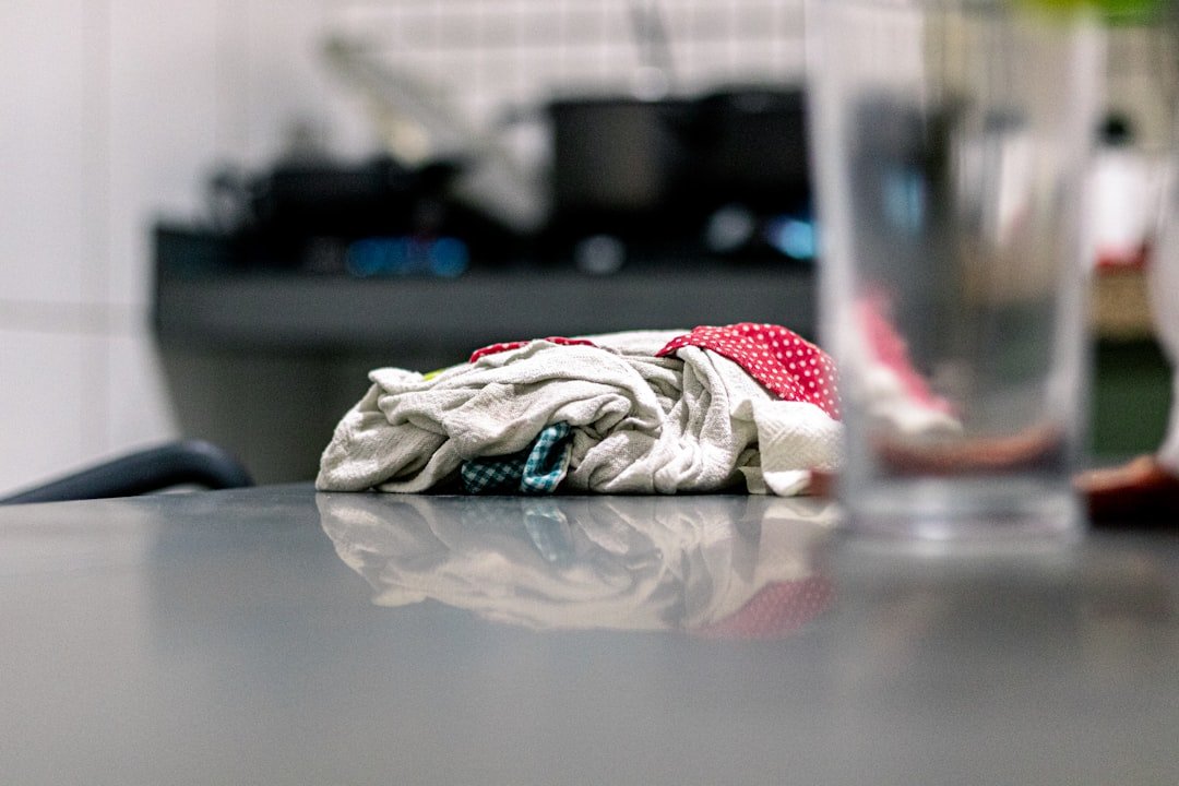 Crumpled cloth on a reflective surface in a blurry kitchen.