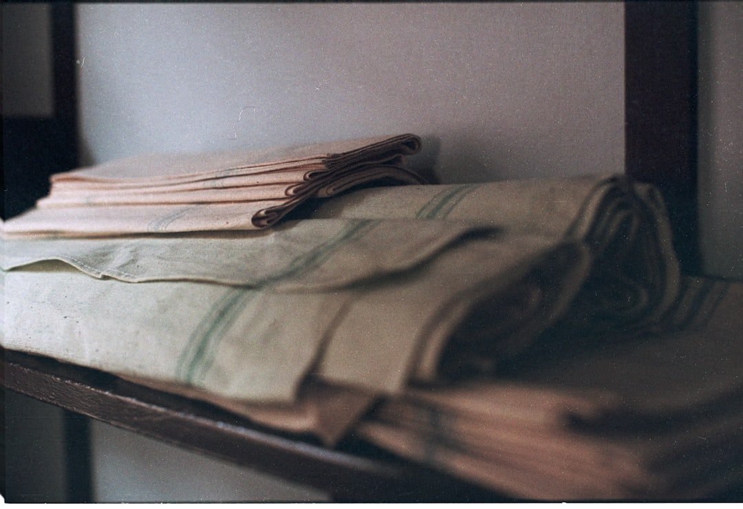 Folded textiles with green stripes on shelf