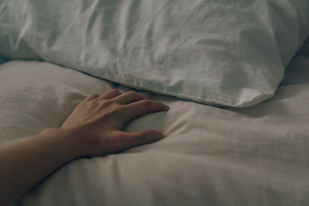 persons left hand on white textile