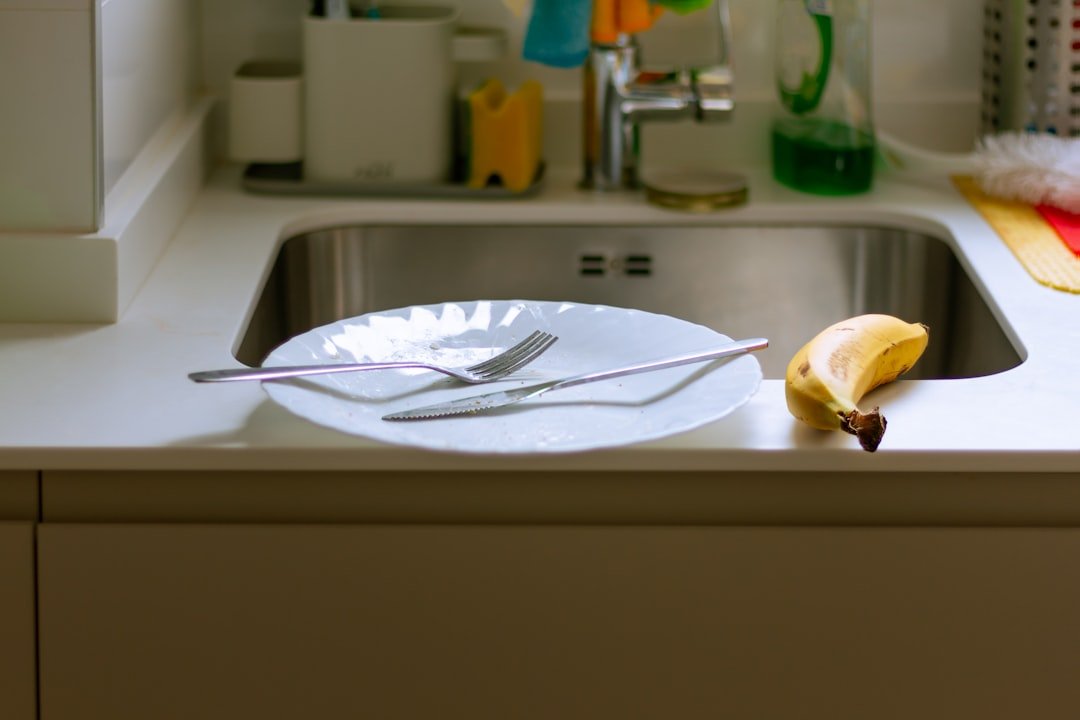 A plate with a knife and fork on a kitchen counter