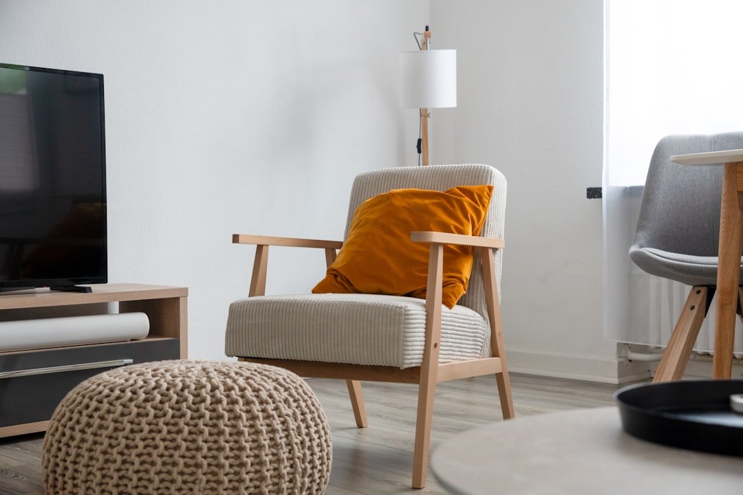 a living room with a couch, chair and television